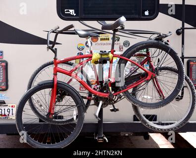 A recreational vehicle, or RV, with bicycles attached to its rear makes a stop in Santa Fe, New Mexico. Stock Photo