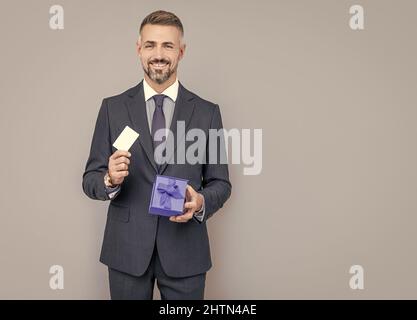 happy ceo share gift certificate. handsome man prepare for romance date. business reward. Stock Photo