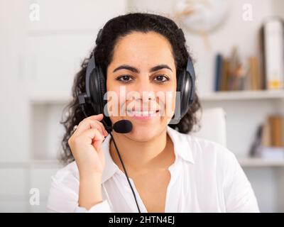Happy call center operator talking with client at office Stock Photo