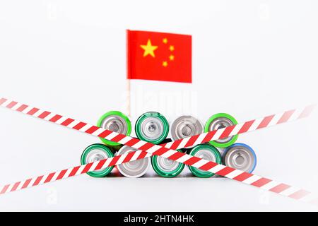 Battery ban in China. Batteries are enclosed with red and white tape. Disposal of waste from batteries. Dump of electronic waste. Stock Photo