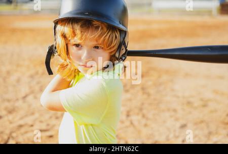 Child baseball player focused ready to bat. Kid holding a baseball bat. Stock Photo