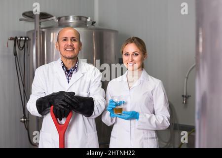 Two brewery workers on beer factory. Stock Photo