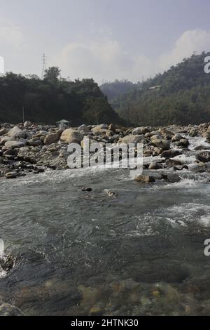 mountain stream (balason river) flowing down to the gangetic plain from himalayan foothills in the terai region of west bengal, india Stock Photo