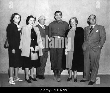 CLARK GABLE on set candid with Sir ALEXANDER KING Glasgow theatre circuit owner and Family and MARK OSTRER head of Gaumont-British cinemas in Great Britain during filming in Hollywood of HOMECOMING 1948 director MERVYN LeROY story Sidney Kingsley costume design Helen Rose Metro Goldwyn Mayer Stock Photo