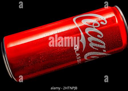 Coca-Cola 330ml aluminum can with water droplets on a black background. A classic sweet drink for all time. Russia, Krasnodar, December 15, 2021 Stock Photo