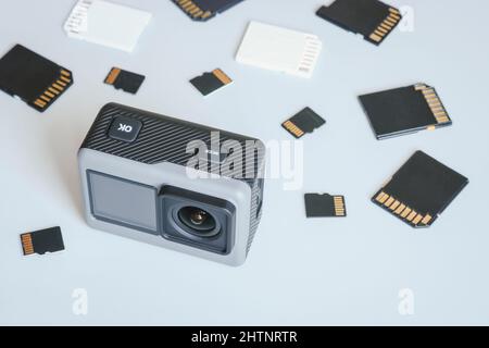 Action camera and SD and MicroSD memory cards. Background from gadgets and digital devices. Stock Photo
