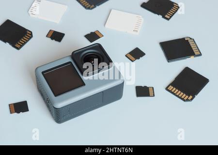 Action camera and SD and MicroSD memory cards. Background from gadgets and digital devices. Stock Photo