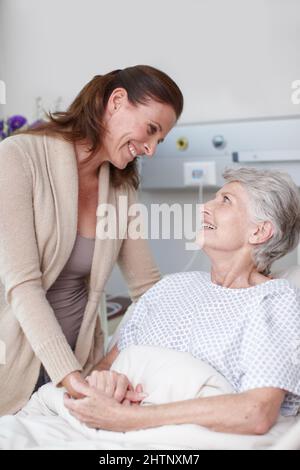The operation was a success. An affectionate daughter visiting her sick mother in the hospital. Stock Photo