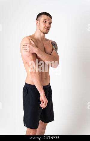 A sore shoulder joint muscle in a white man on a white background pain ...