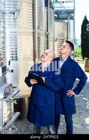 Worker taking notes in fermentation section Stock Photo
