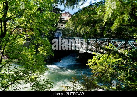 a bridge over the the turquoise river Passer in the gorgeous Italian town Merano in South Tyrol (Italy, Autonomous Province of Bolzano – South Tyrol) Stock Photo