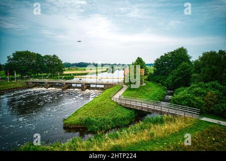 Drone view of the river the Vecht, beautiful blue sky and cycle path. Bridge and weir in the river. Flying drone in the sky. Dalfsen Netherlands Stock Photo