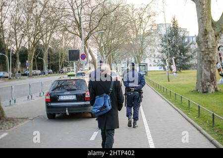 Strasbourg, France - Mar 24, 2015: Rear view of people walking in city center of Police officers surveilling the area near Council of Europe building Stock Photo