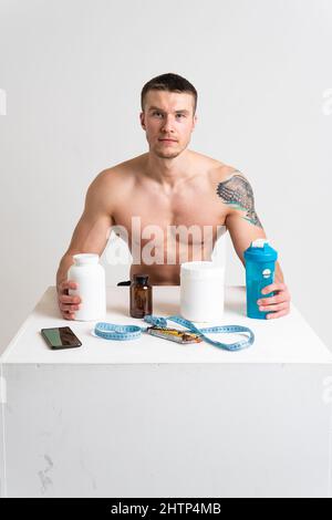 Fitness protein jars white on white background bodybuilder powder strong high back body backache sick white health muscular Tension sickness, disease Stock Photo