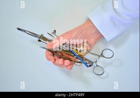 doctor holds surgical instruments in his hands Stock Photo