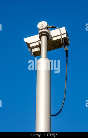 CCTV security camera system being used for surveillance with a clear blue sky, stock photo image with copy space Stock Photo