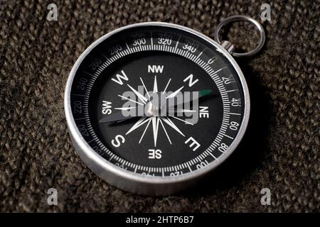 close up of compass on knitted garment Stock Photo