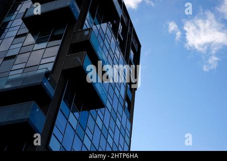 dark apartment block on blue sky background Stock Photo
