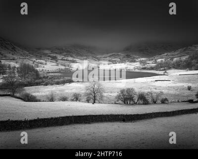 An infrared image of Little Langdale Tarn with the Tilberthwaite Fells and Wrynose Fell beyond in the English Lake District National Park, Cumbria, England. Stock Photo