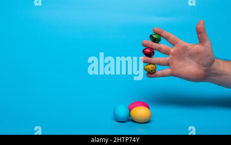 Easter eggs and fingers with quail eggs Stock Photo