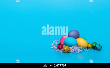 multi-colored easter eggs on a blue background Stock Photo