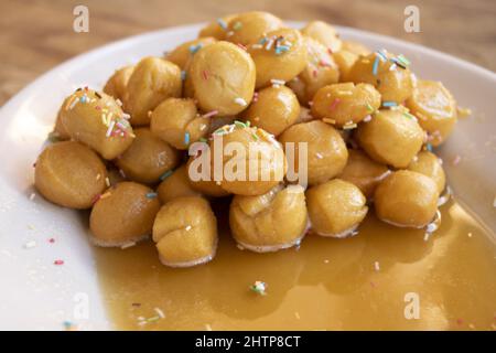 pignolata typical Sicilian and Calabrian dessert that is prepared for carnival Stock Photo