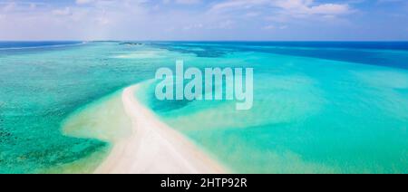 Sandbank beach for holidays vacation with white sand and turquoise blue transparent water. Aerial view from drone. Pristine tropical atoll island in M Stock Photo