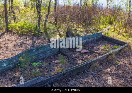 Old abandoned wooden rowing boat in bad conditions Stock Photo