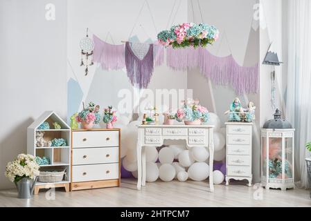 Kids interior with Easter decorations, toys and flowers Stock Photo