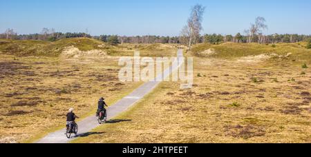 Panorama of a senior couple on bicycles in the national park Drents-Friese Wold, Netherlands Stock Photo