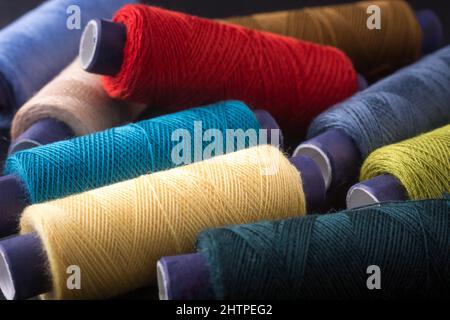 Premium Photo  Texture of blue thread in spool for sewing on a plain blue  background close up clothing