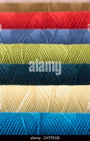 spool of sewing thread abstract, fabric and textile industry background, different colors, taken in shallow depth of field Stock Photo