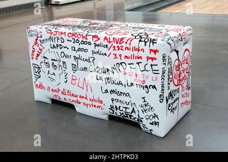 The rear of a plywood and foam imitation of an NYPD police barrier that viewers are invited to write on. At the Queens Museum in New York City. Stock Photo