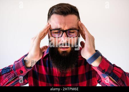 Portrait of man who is tired and having headache. Copy space on image for your text or advert. Stock Photo