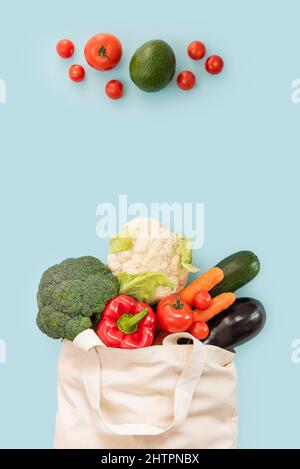 Copy space top view of a bag of fresh vegetables on blue background with space for text Stock Photo