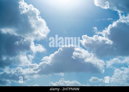 Blue sky with beautiful clouds and shining sun Stock Photo