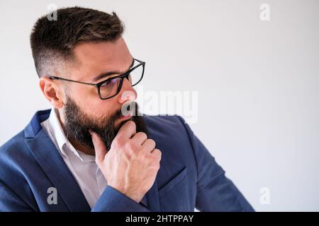 Portrait of businessman who is thoughtful and worried. Copy space on image for your text or advert. Stock Photo