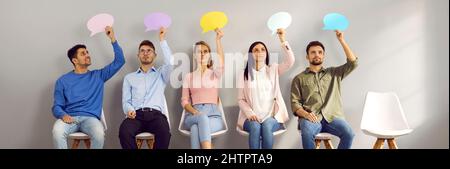 Group of young people holding speech bubbles, thinking about something and sharing opinions Stock Photo