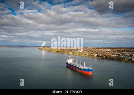 Cargo ship, bulk carrier, anchored near the Port of Montreal on the St. Lawrence River. Stock Photo