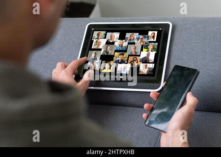 Remote Work Communication. Businesswoman Holding Tablet Having Online Meeting With Group Of Coworkers Making Video Call Via Computer Sitting In Modern Stock Photo