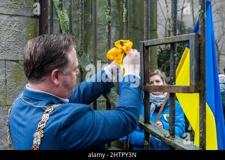 Cork, Ireland. 2nd Mar, 2022. Around 100 people gathered in Bishop Lucey Peace Park in Cork city today, in solidarity with the people of Ukraine. The Cork Lore Mayor, Cllr. Colm Kelleher, laid a wreath and tied a ribbon to the gates of the park. Credit: AG News/Alamy Live News Stock Photo