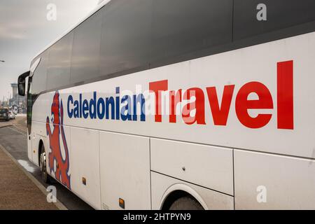 Caledonian Travel coach parked on side of road Stock Photo