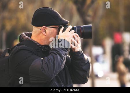 Beautiful shot of a Caucasian man photographing something with a camera Stock Photo