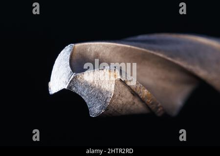 The tip of a drill for metal close-up on a dark background. Macro photography Stock Photo