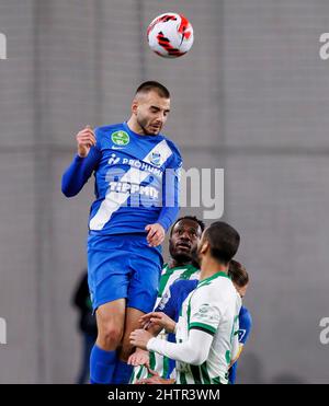 Ivan Petryak of MOL Fehervar FC dribbles between Franck Boli of
