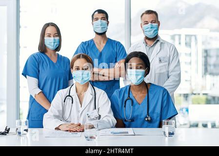 Teamwork allows us to cut down on medical errors. Portrait of a group of medical practitioners having a meeting in a hospital boardroom. Stock Photo