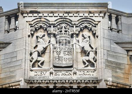 Stone sculpted royal coat of arms on an outside wall of King's college, university of Cambridge, England. Stock Photo