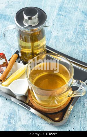 Hot winter tea served with a french press on a wooden table Stock Photo