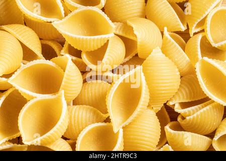 Raw uncooked dry Conchiglioni italian pasta. shells shaped Stock Photo