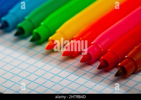 Image of opened multicolored markers on notepad Stock Photo
